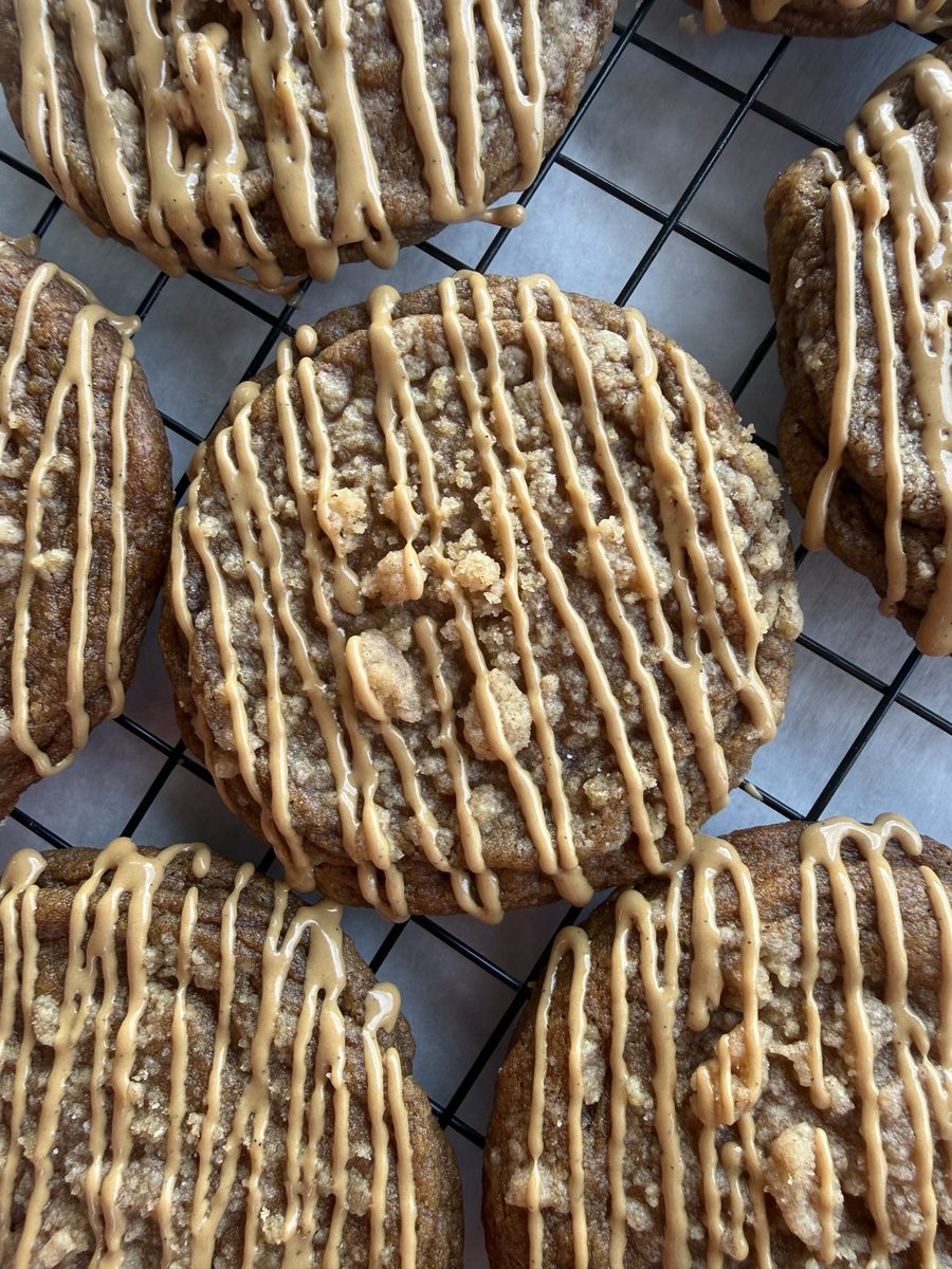 Pumpkin spice latte drop cookies with espresso glaze drizzle on a cooling rack